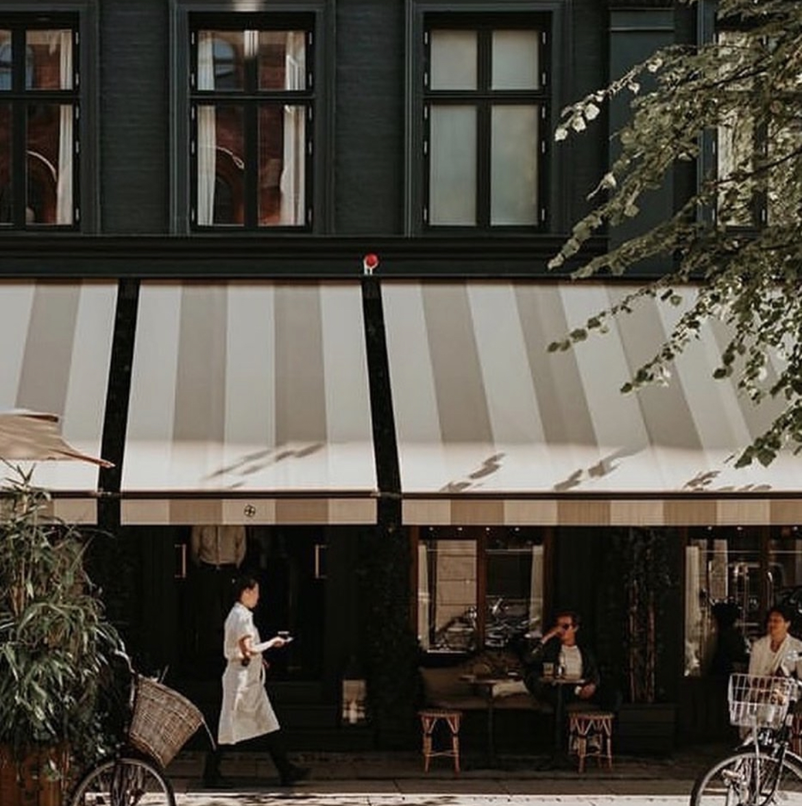 a streetside cafe - Courtesy of Hotel Sanders 
